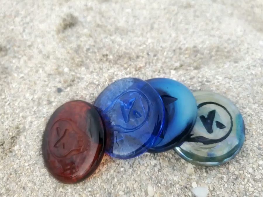Kudoken coins close up on sand